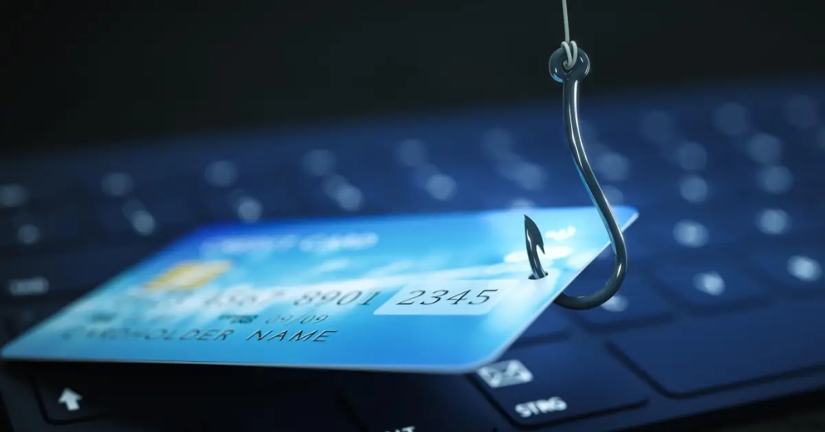 Credit card and phishing hook representing financial risk and online fraud in property transactions