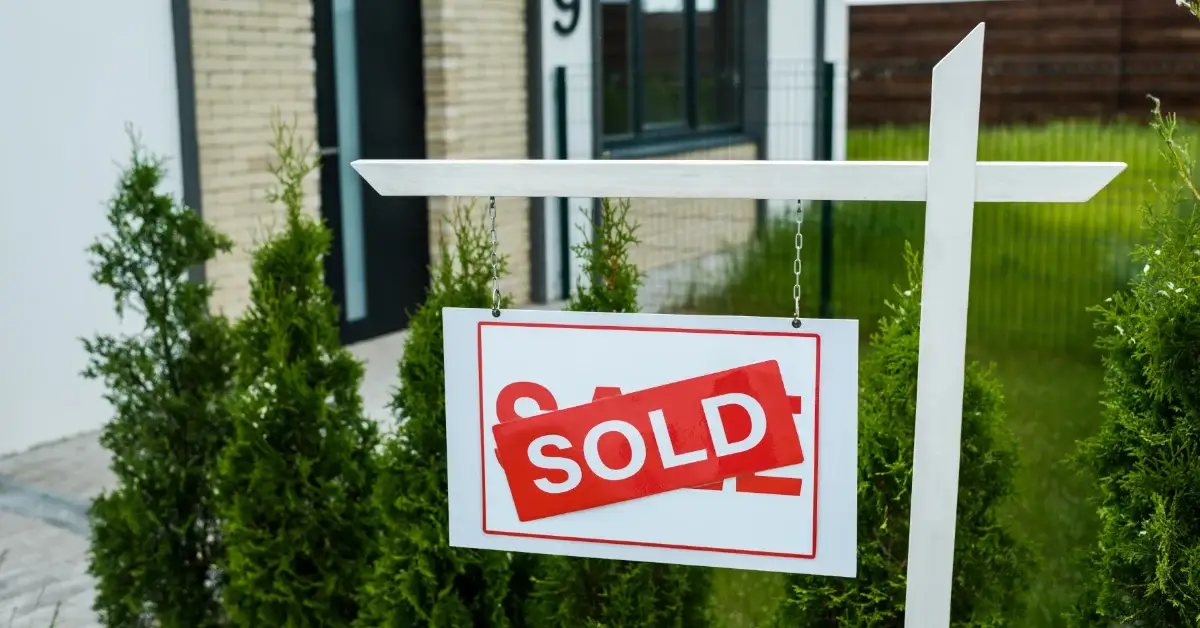 Sold sign outside residential property representing completed property sale and conveyancing completion