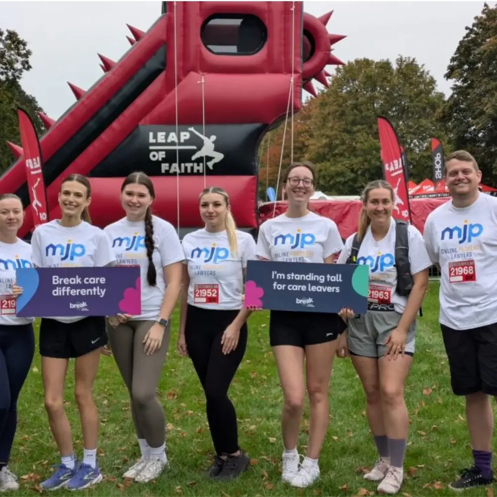 MJP team members at a charity event with inflatable obstacle supporting care leavers