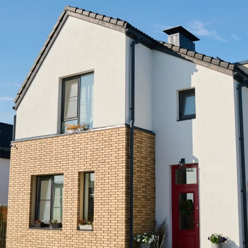 Modern two-storey brick and rendered home with red front door